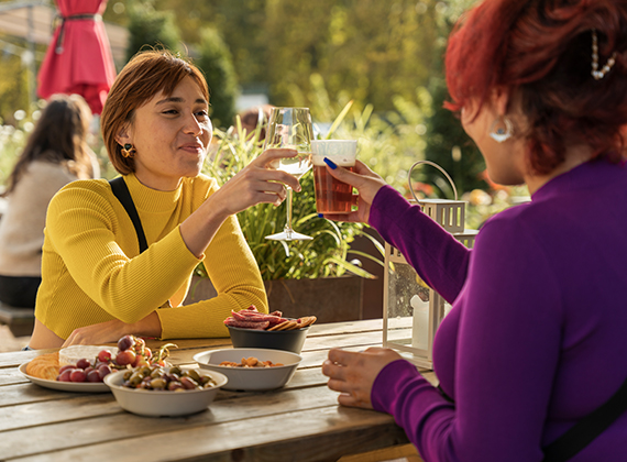 Friends dining outside with reusable plates and glasses